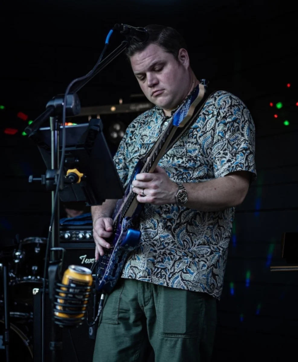 Clyde’s Electric Chalkboard guitarist performing live